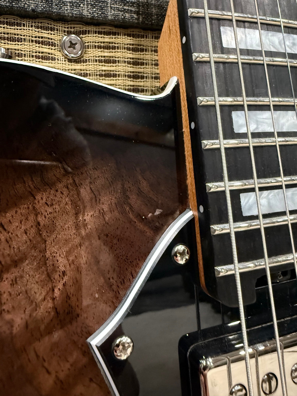 Close-up of the chip on the face of Veritas Portlander #3338 beside the neck and pickguard